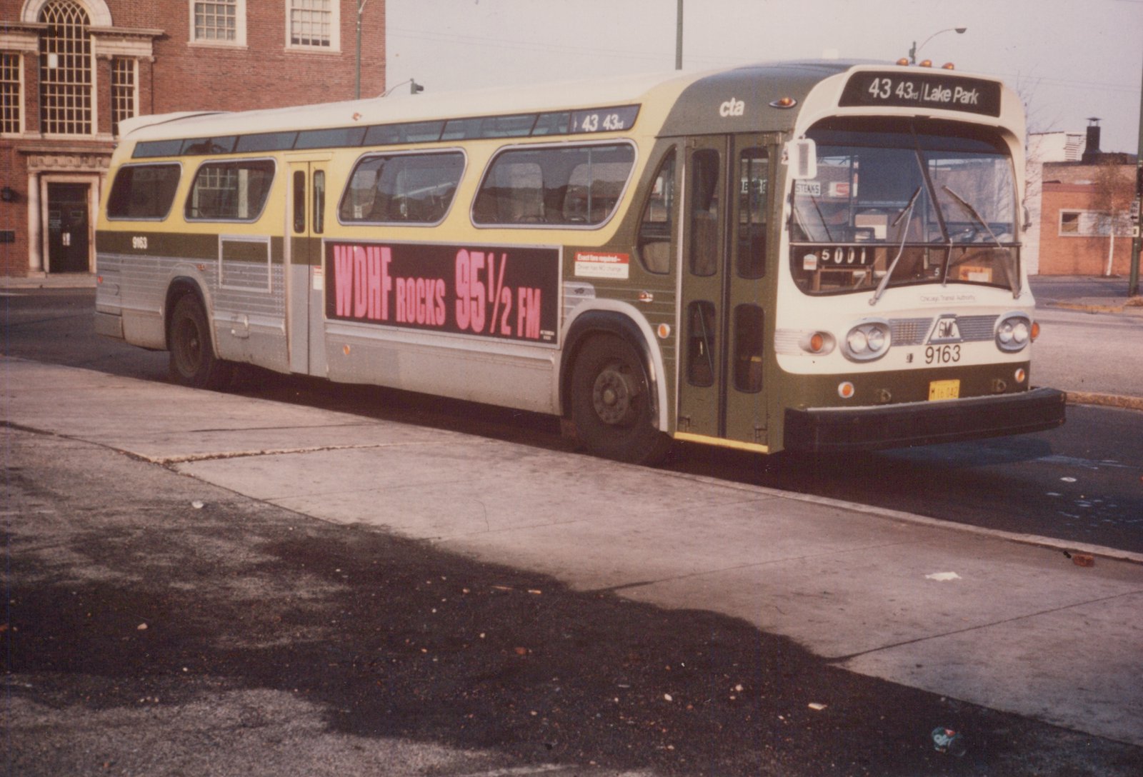A green and cream Chicago Transit Authority motor bus, number 9163, is parked on a street, with a sign showing route 43 to Lake Park and an advertisement for WDHF Rocks 95½ FM.