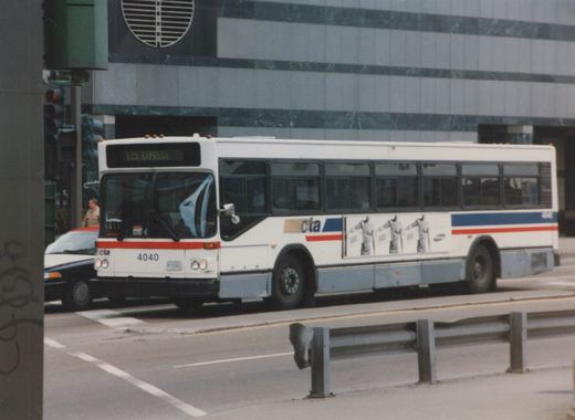 A white CTA bus with red and blue stripes, fleet number 4040, is driving on a city street; the destination sign reads '125 EXPRESS' and the location is Wacker and Franklin.