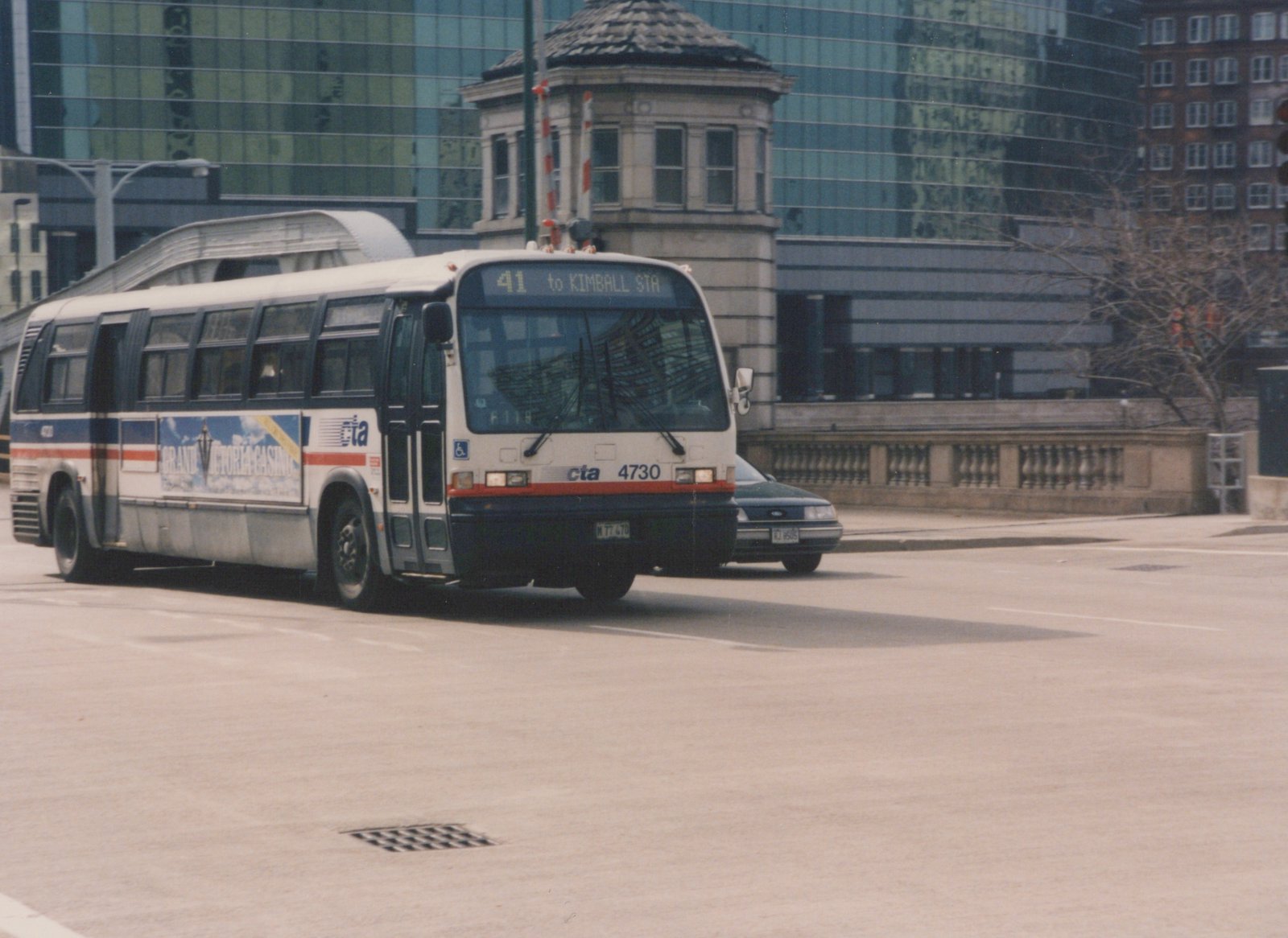 A Chicago Transit Authority bus, number 4730, on route 41 to Kimball Station, driving on a city street with modern buildings in the background.