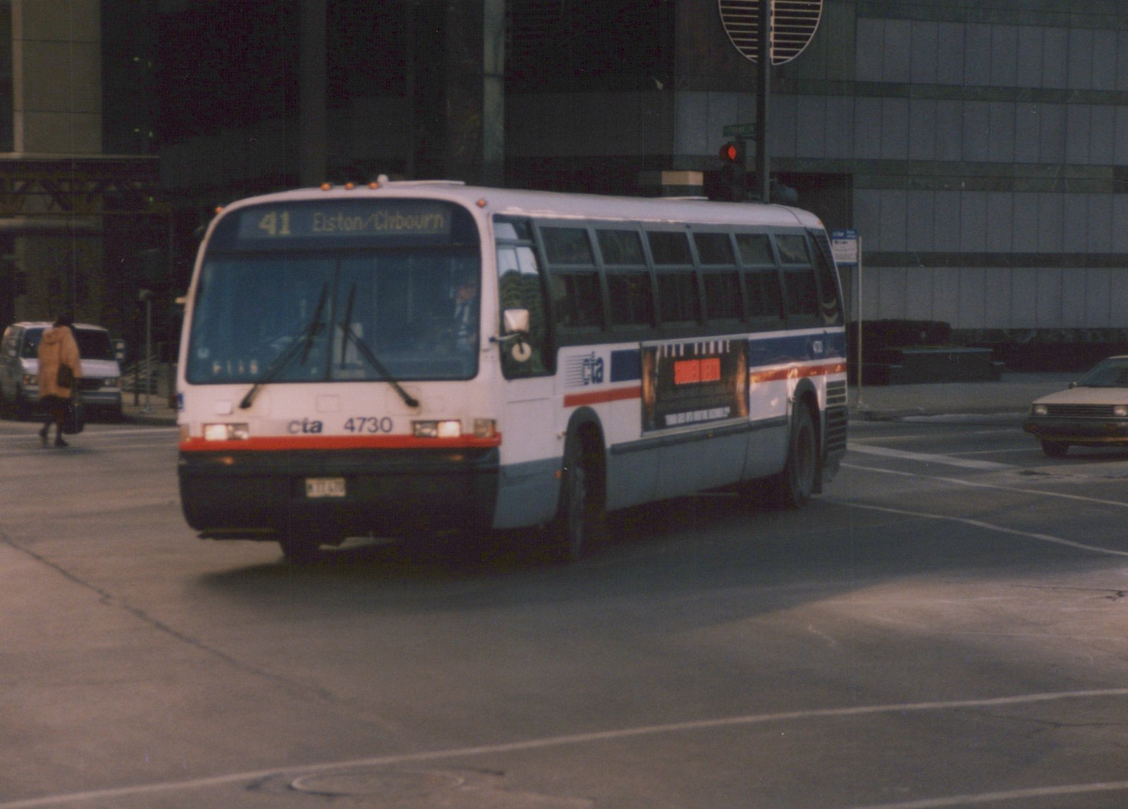 A white and blue Chicago Transit Authority bus with the number 4730 is driving on a city street, with a destination sign reading '41 Elston/Clybourn' and a street sign for Franklin visible in the background.