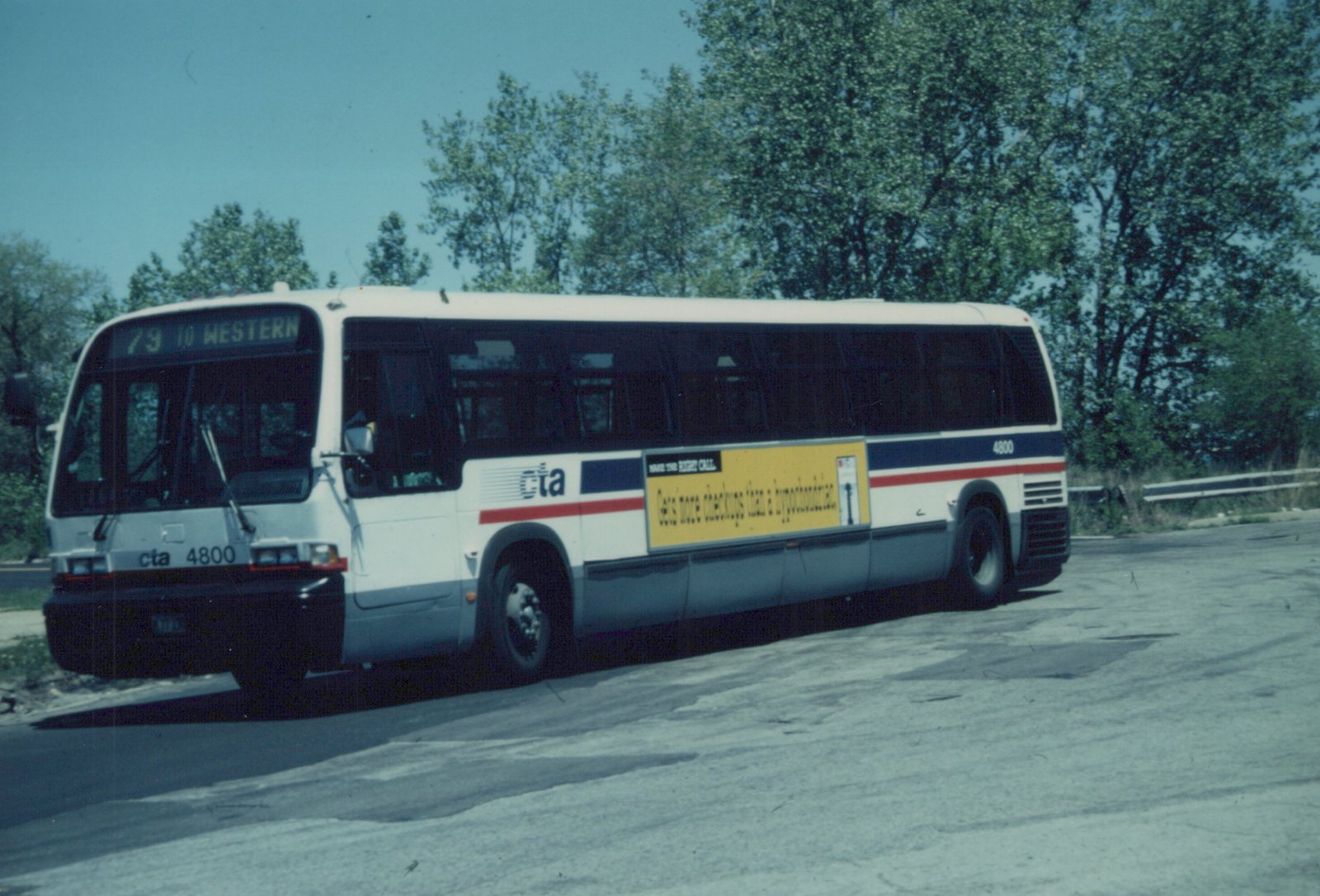 A white Chicago Transit Authority motor bus numbered 4800, displaying route 79 to Western, parked on a street with trees in the background.