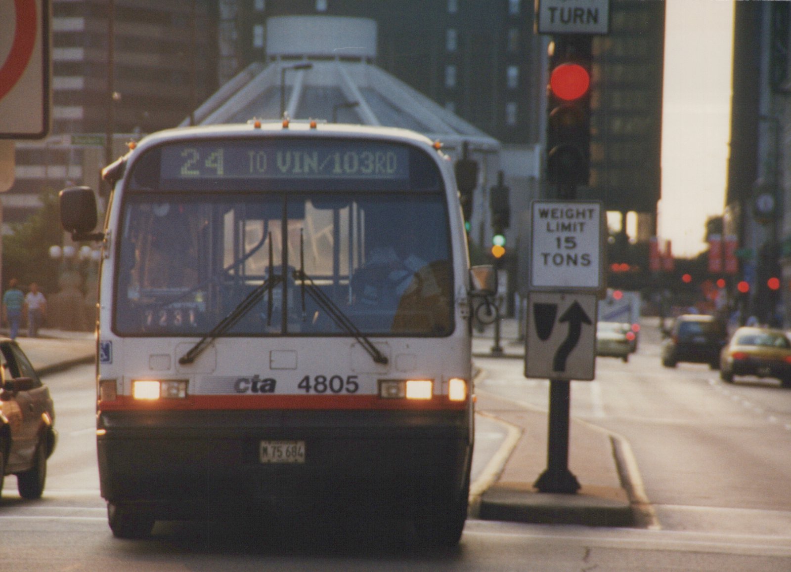 Front view of a white and red Chicago Transit Authority bus, number 4805, showing route 24 to Van Buren/103rd Street, stopped at an intersection with a 'Weight Limit 15 Tons' sign nearby.