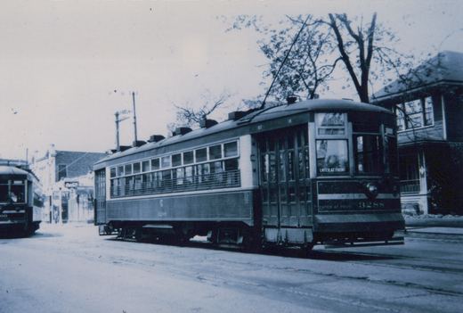 A black and white photograph of two Chicago North Shore and Milwaukee interurban cars on a snow-covered street in Milwaukee, with car 3288 in the foreground showing its destination as Montrose.