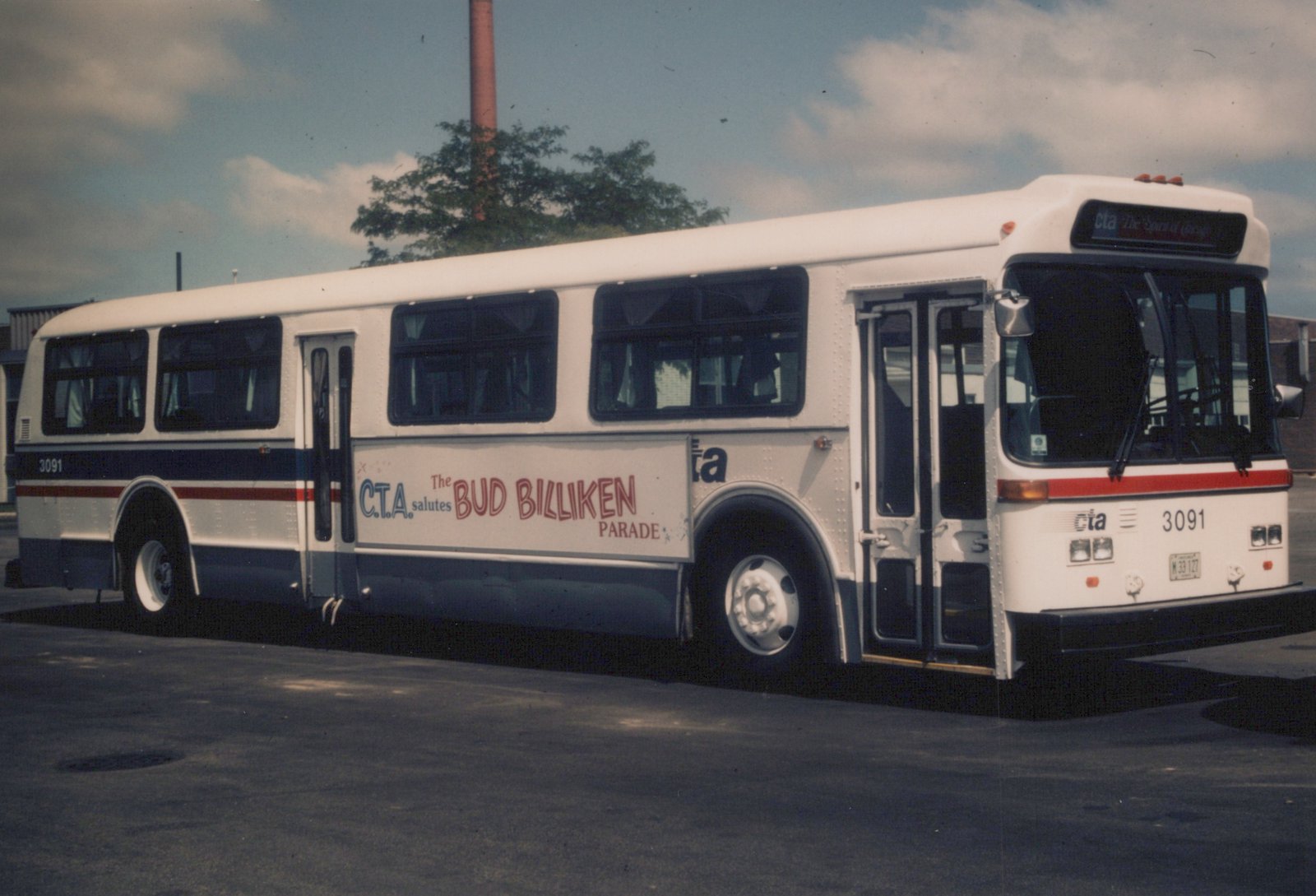 A white and blue Chicago Transit Authority bus, number 3091, with a Bud Billiken Parade ad on its side, parked outdoors on an overcast summer day.