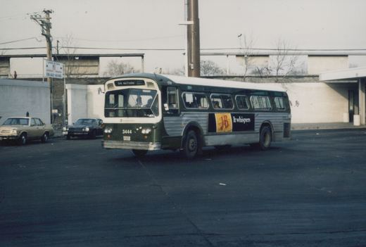 A green and silver CTA bus with the number 3444 is parked at a terminal, with cars and a sign for Jefferson Park Garage in the background.
