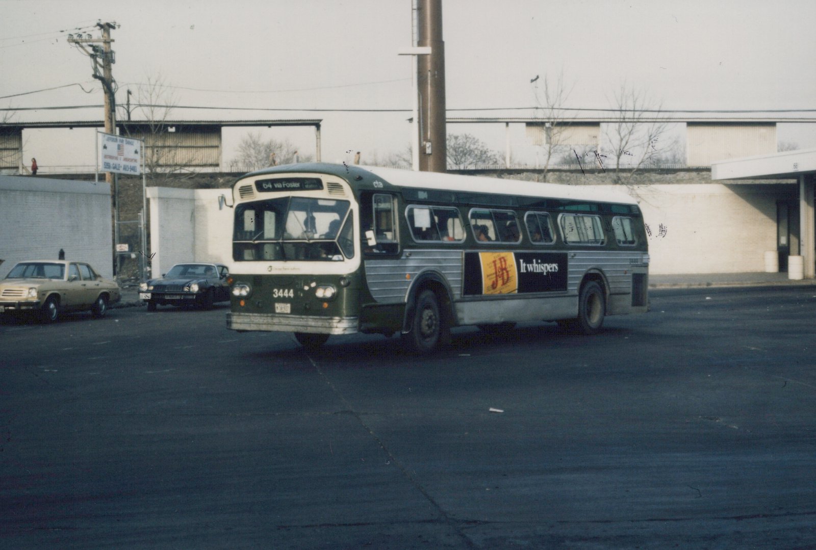 A green and silver CTA bus with the number 3444 is parked at a terminal, with cars and a sign for Jefferson Park Garage in the background.