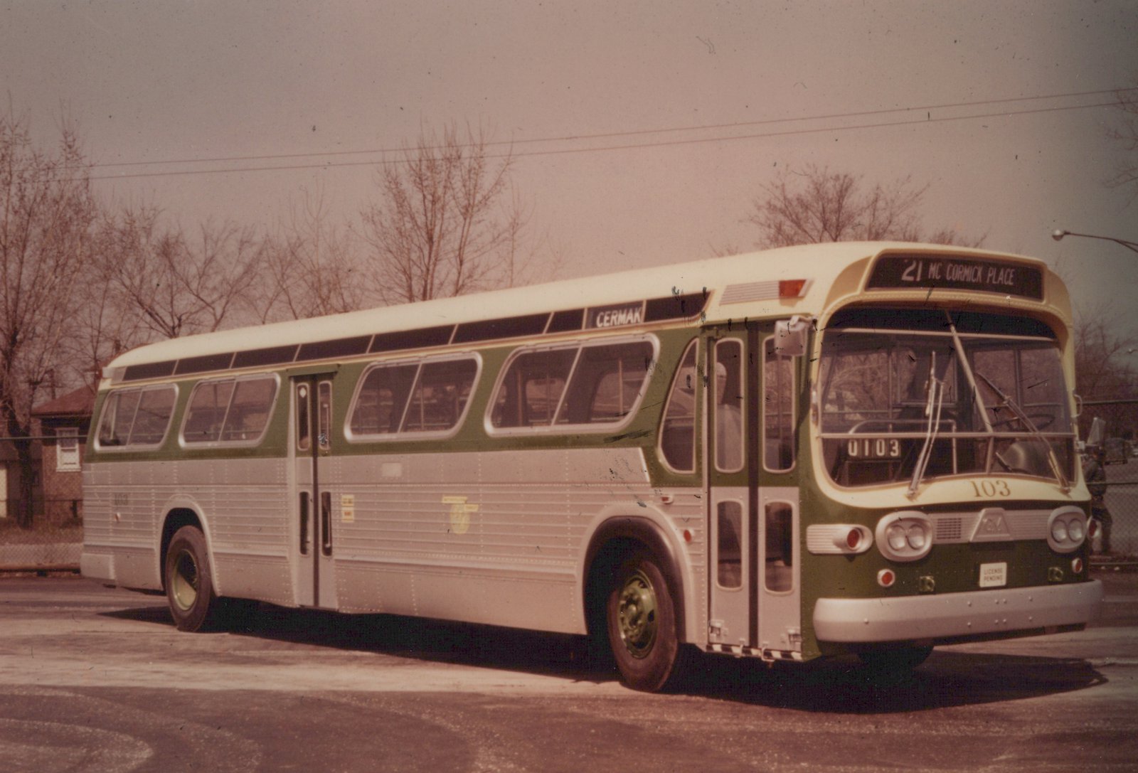 A three-quarter front view of a vintage Chicago Transit Authority motor bus, number 0103, painted green and silver, with a destination sign reading '21 MC CORMICK PLACE' and a side sign reading 'CERMAK'.