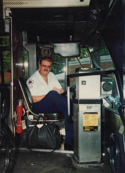 Interior view of a bus showing the driver in uniform, seated at the wheel, with a farebox displaying the number 5367 and operator CTA.