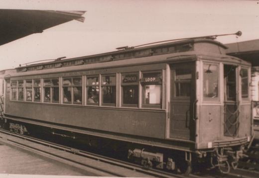 A vintage black and white photo of a 4000-series 'L' car, numbered 2900, at a station with its destination sign 'LOOP' visible.