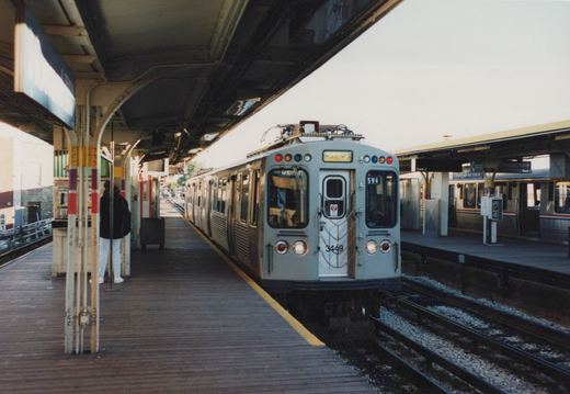 A gray CTA rapid transit car, number 3449, is stopped at the Howard Terminal platform with another car visible on the adjacent track.