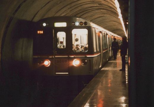 A silver CTA subway car with red and blue stripes, number 2669, stopped at a station platform in a tunnel, with the route number 1136 displayed on its front sign.