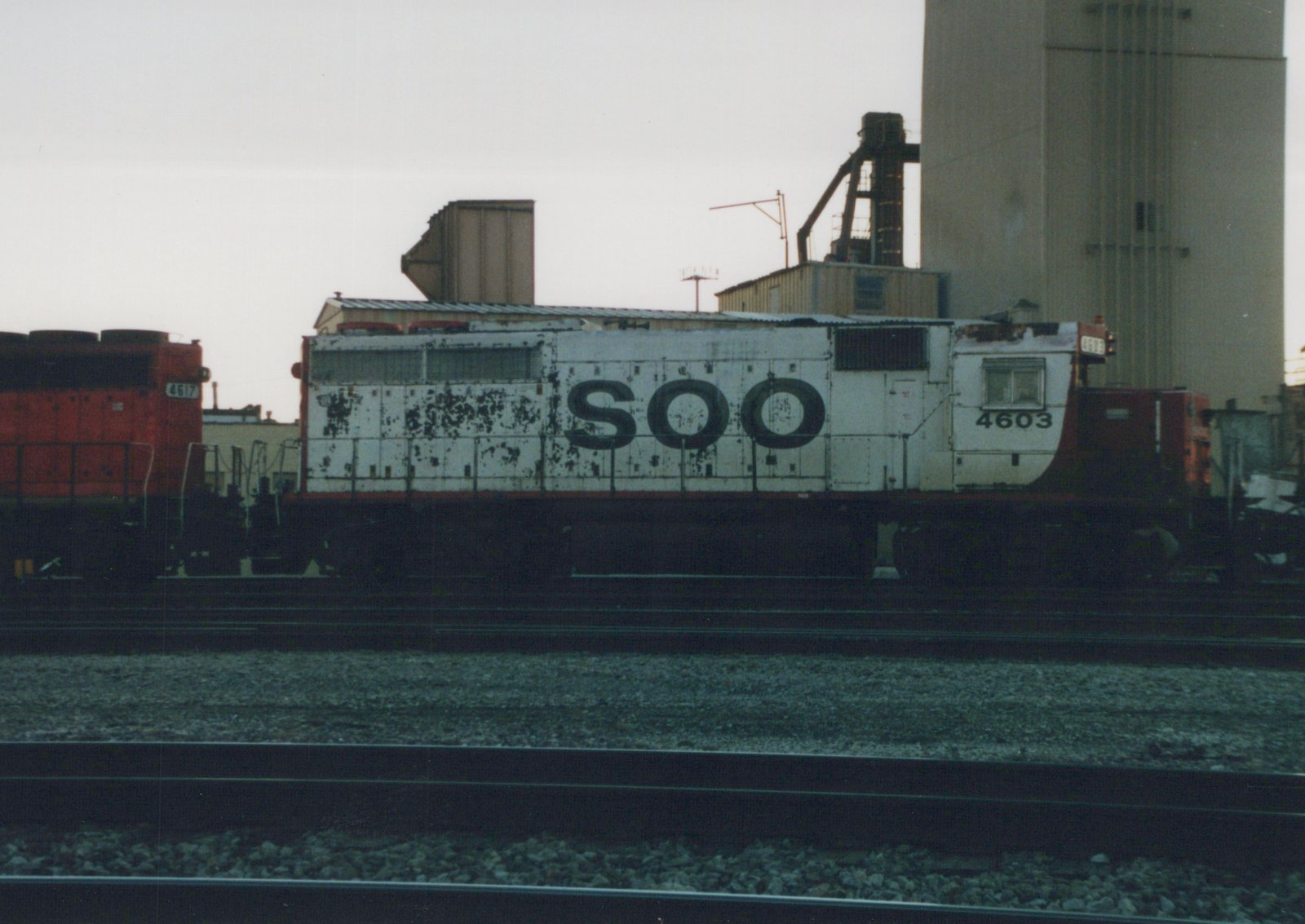 Two SOO Line diesel locomotives, numbers 4603 and 4617, side-by-side on tracks in a yard under an overcast sky.