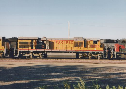 A yellow and gray Union Pacific diesel locomotive, number 2656, is parked in a rail yard with another locomotive partially visible behind it.