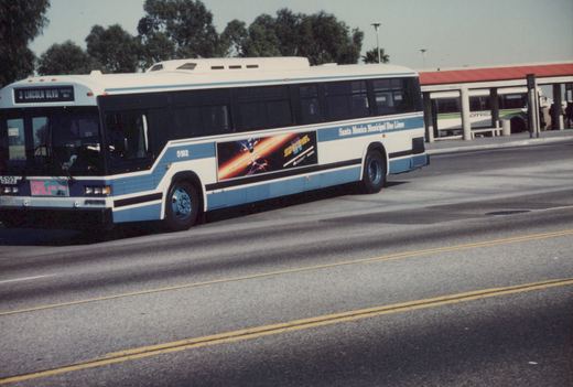 A white and blue Santa Monica bus, number 5192, is shown from the side on a sunny day, with a 'Star Trek' ad on its side and a terminal in the background.