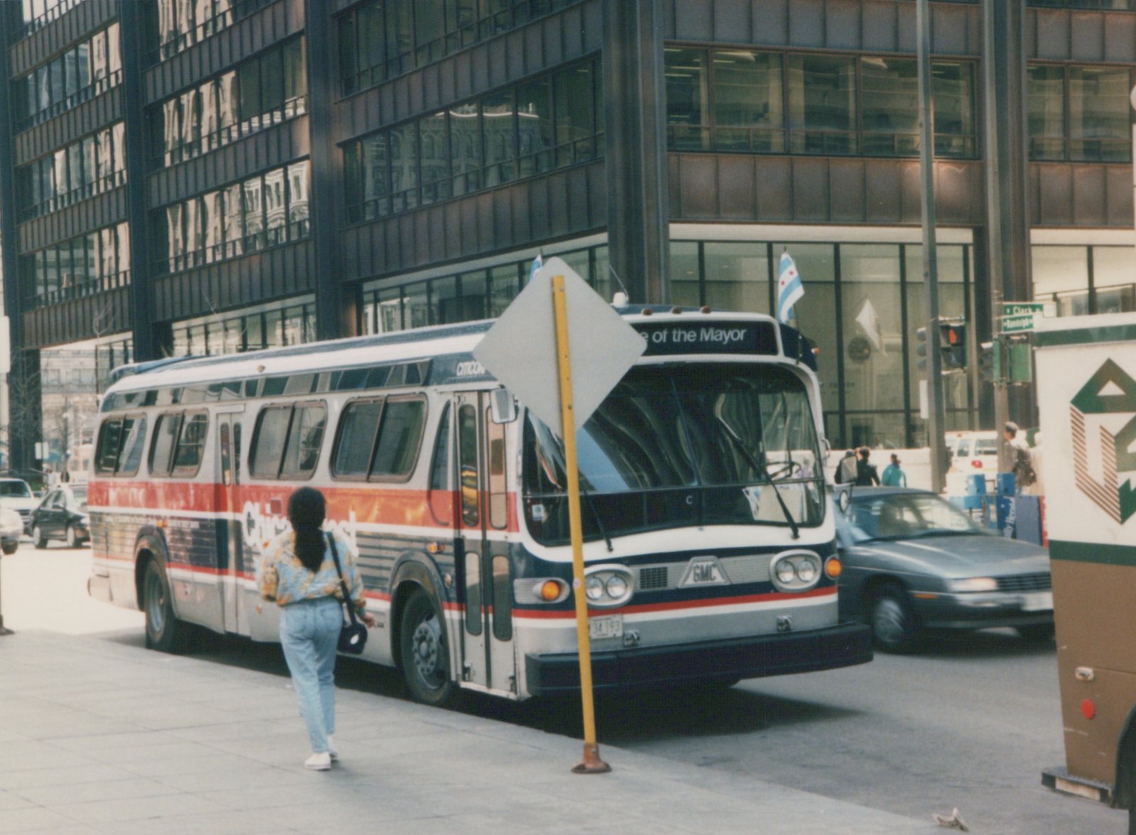 A three-quarter front view of a white, red, and blue Chicago Transit Authority bus, number 34193, parked on a city street with a pedestrian visible and a building in the background.
