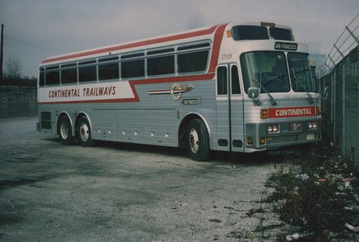 A silver and red Continental Trailways motor coach, number 27529, is parked in a paved lot next to a chain-link fence, with 'San Francisco' displayed on its front sign.