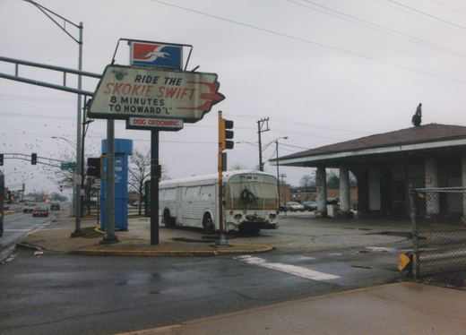A white bus with the number BW 55 is parked at a street corner next to a large sign that reads 'RIDE THE SKOKIE SWIFT 8 MINUTES TO HOWARD 'L''.