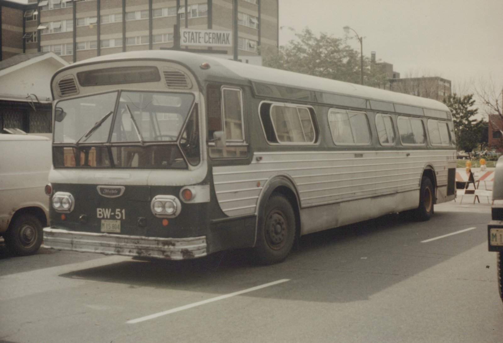 A green and white CTA bus, model Flxible New Look, number BW-51, is parked on a street with a 'STATE-CERMAK' street sign visible in the background.