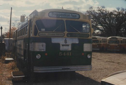 Front view of a vintage Chicago Transit Authority bus with 'Suggestion bus' on its sign, parked in a yard with other buses visible behind it.