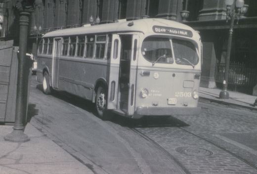 A black and white photo of a Chicago Transit Authority bus number 2503, a GM New Look model, parked on a cobblestone street with a destination sign reading DU46 KUSTNER.