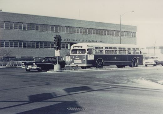 A black and white photograph of a Chicago Transit Authority Flxible bus numbered 7206 on a city street in winter, with vintage cars and a building labeled 'Air Line Pilots Association Int'l' in the background.
