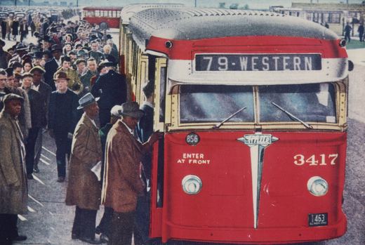 A front view of a red and cream Chicago Surface Lines bus, number 856, with the destination '79-WESTERN' displayed, as passengers board on a crowded street.