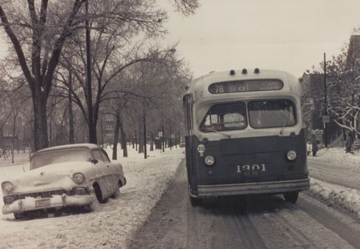 A vintage black and white photo shows a CTA bus on a snow-covered street with a 1950s car parked nearby and bare trees lining the road.