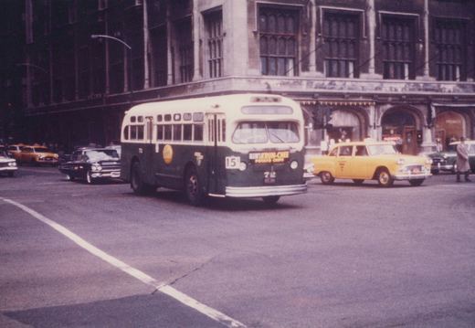 A vintage Chicago Transit Authority bus numbered 72 is driving on a city street, surrounded by 1960s-era cars and a large stone building in the background.