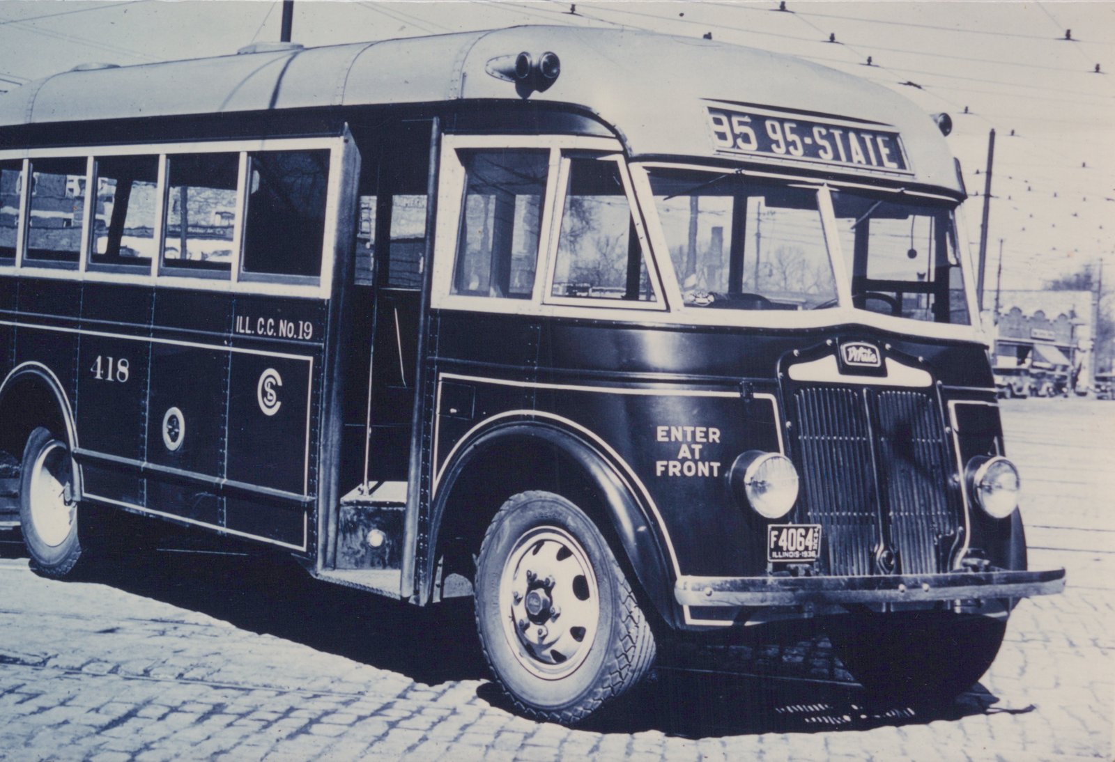 A vintage black-and-white photo of a 1936 Chicago Surface Lines motor bus, number 418, on a cobblestone street, showing its front and side with a '95 95-STATE' route sign and a 1936 Illinois license plate.