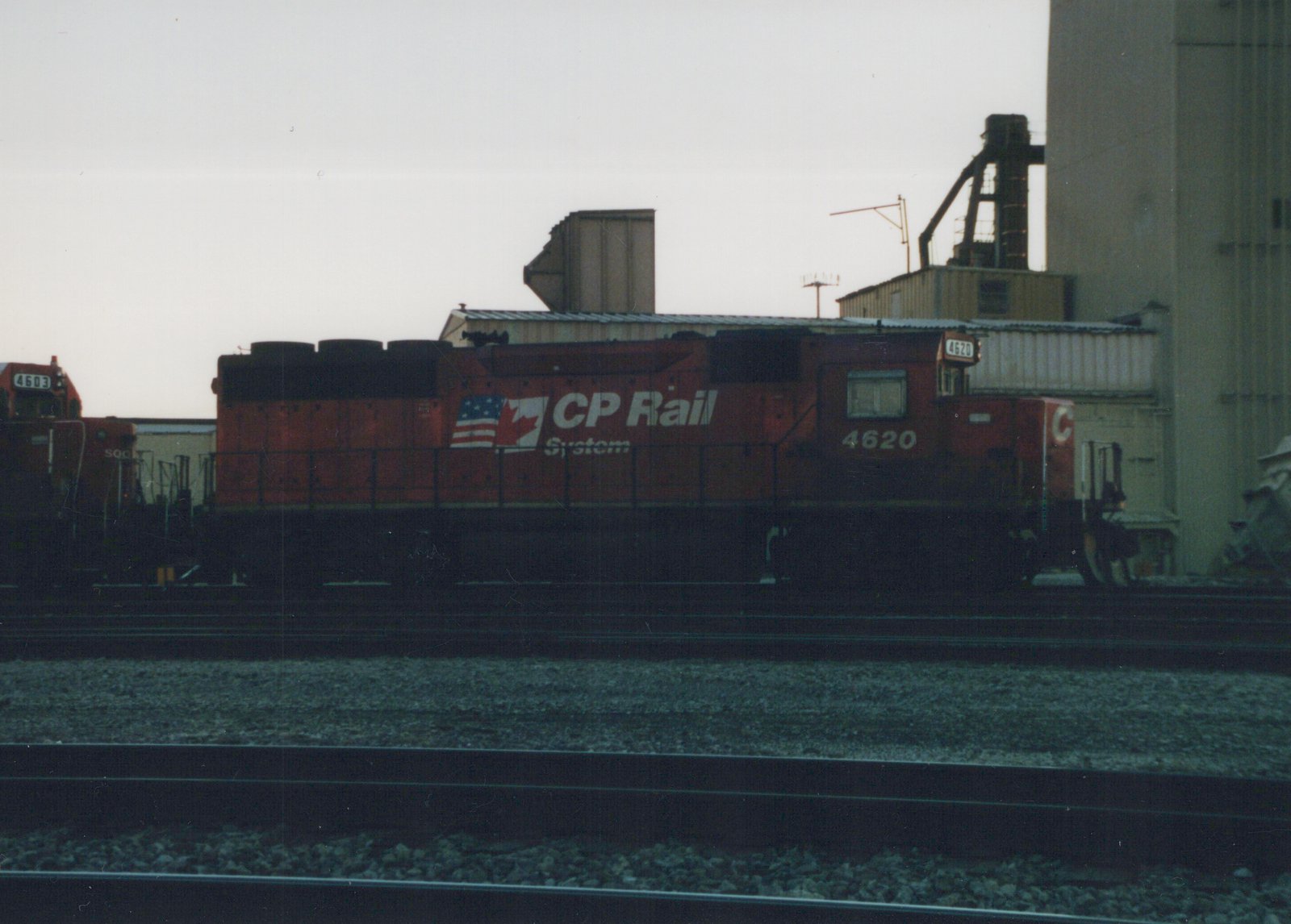 A red CP Rail locomotive with the number 4620 on its side and front, parked on tracks in a rail yard with another locomotive visible in the background.