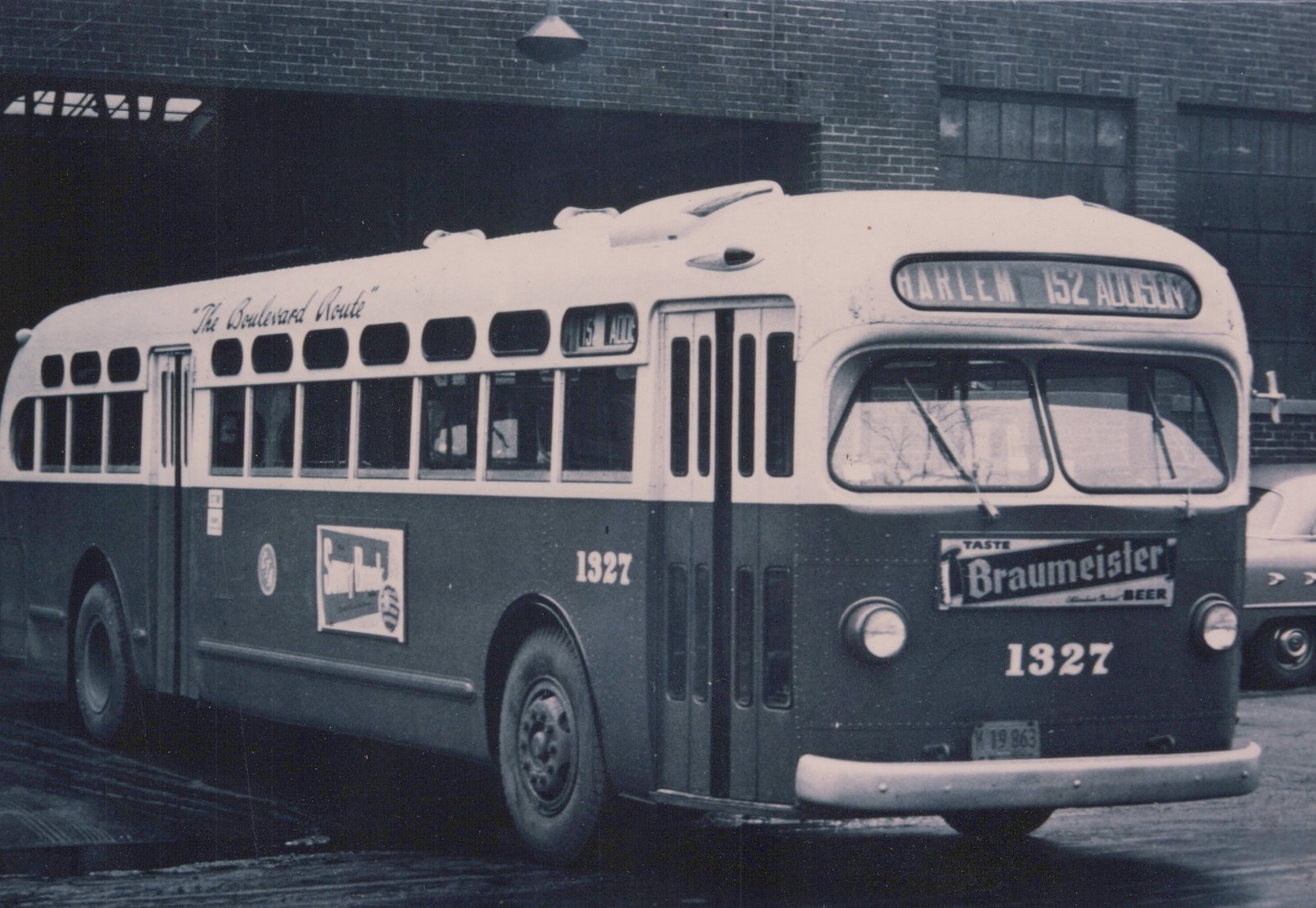 A vintage black-and-white photo of a Chicago Transit Authority bus, number 1327, with 'The Boulevard Route' written on its side and 'HARLEM 152 ADDISON' on its front sign, parked near a brick building.