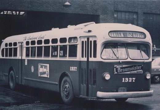 A vintage black-and-white photo of a Chicago Transit Authority bus, number 1327, with 'The Boulevard Route' written on its side and 'HARLEM 152 ADDISON' on its front sign, parked near a brick building.