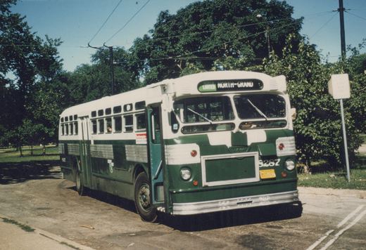 A green and white city bus with the number S287 on its front and side, parked on a paved street with trees and overhead wires in the background, displaying 'NORTH LIMITED NORTH-GRAND' on its destination sign.