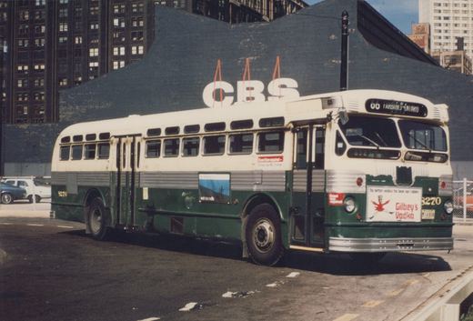 A vintage green and cream motor bus with the number 3270, operated by the Chicago Transit Authority, is shown parked on a city street with a large CBS billboard behind it.