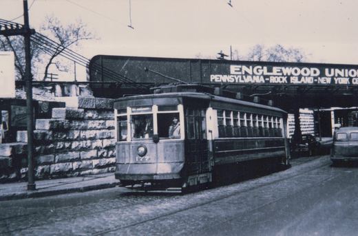 A vintage black-and-white photo of a Chicago Surface Lines streetcar numbered 177, with an elevated railroad bridge labeled 'Englewood Union' behind it, and parked cars nearby.