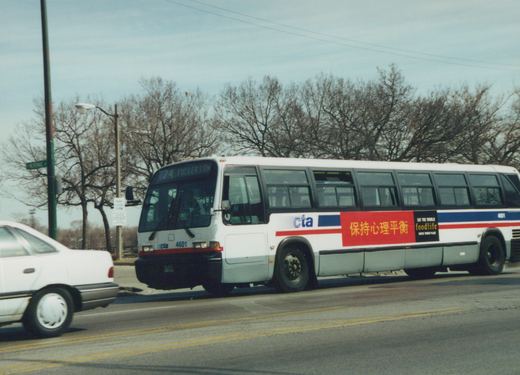 A white Chicago Transit Authority bus with the number 4601 is on a city street, displaying route 74 Fullerton. A street sign for Merimac Street is visible, and trees in the background have no leaves.