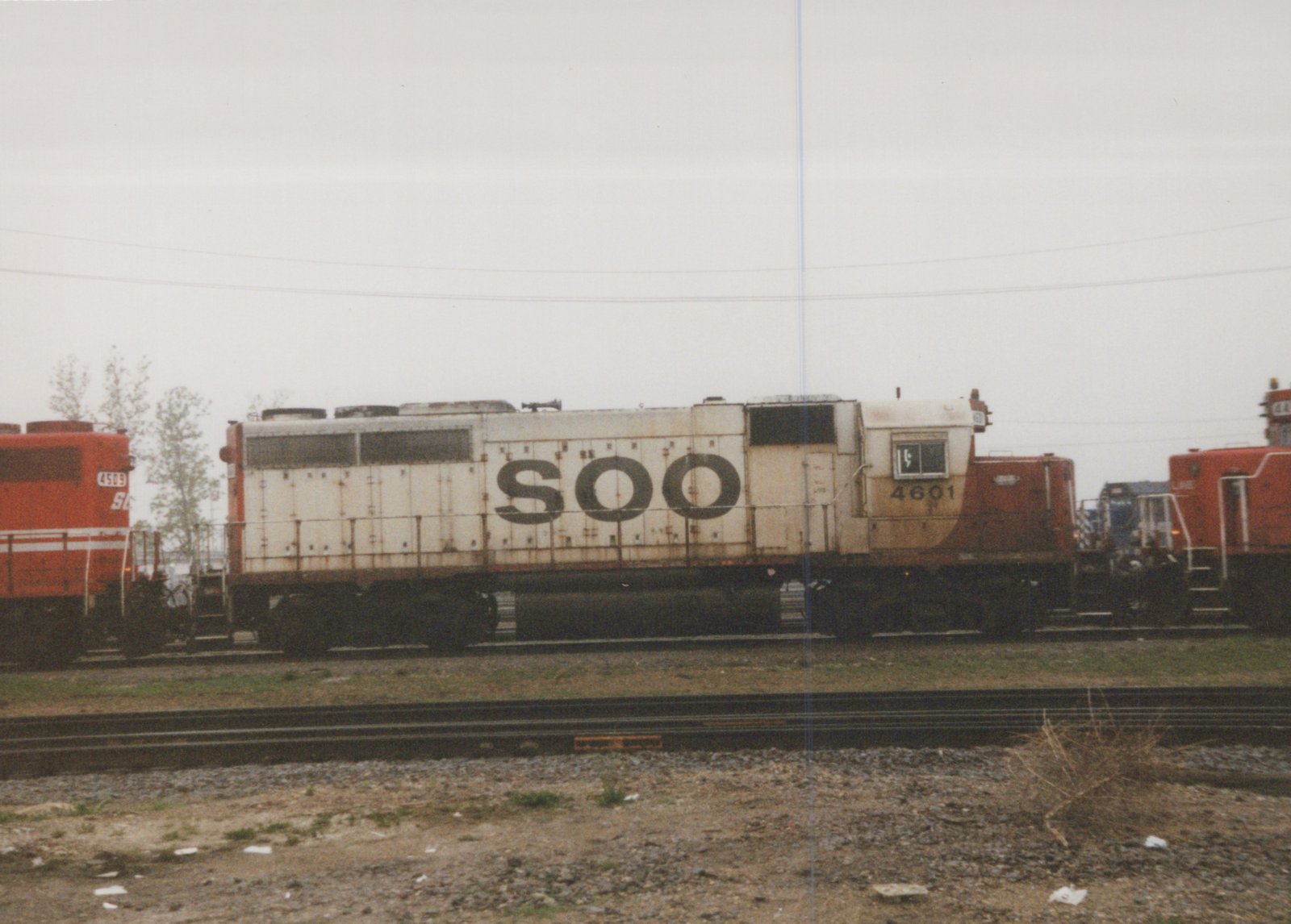 A side view of a Soo Line SD40-2 locomotive, number 4601, in a rail yard, with another Soo Line locomotive, number 4509, partially visible behind it on an adjacent track.