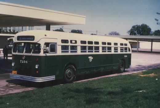A green and cream CTA bus numbered 7294 is parked at a terminal with a clear sky overhead, displaying its route to Lawrence-Marine Dr.
