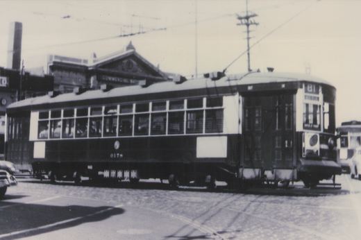 A vintage black-and-white photo of a Chicago Surface Lines streetcar, number 6178, on a city street with a building labeled 'Commercial Wharf' behind it.