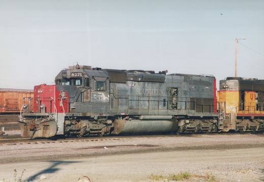Two diesel locomotives, one Southern Pacific and one Union Pacific, are coupled together in a rail yard.